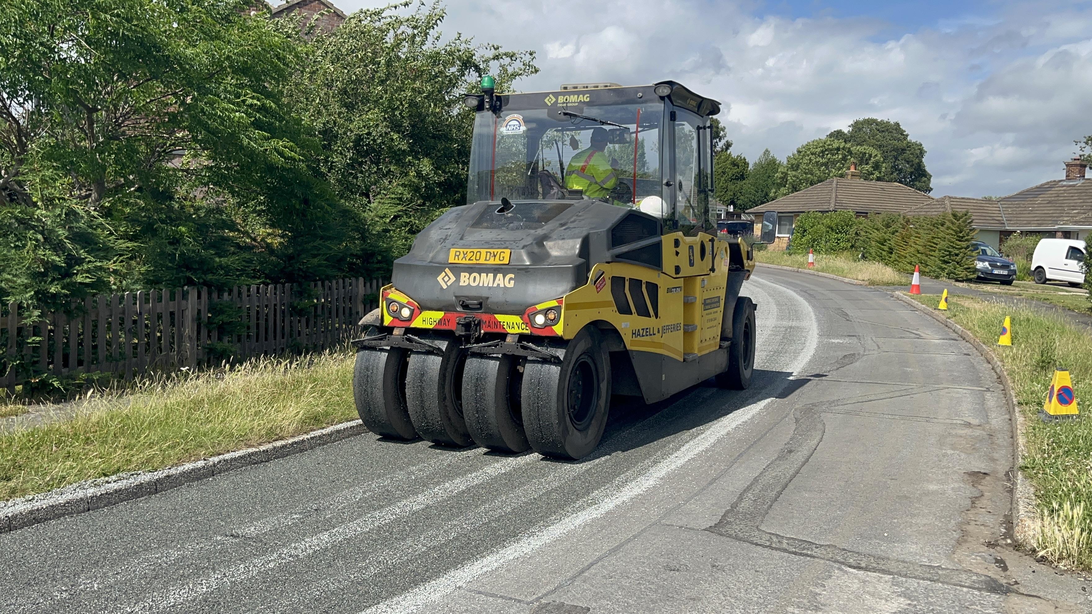 Image of a yellow surface dressing vehicle