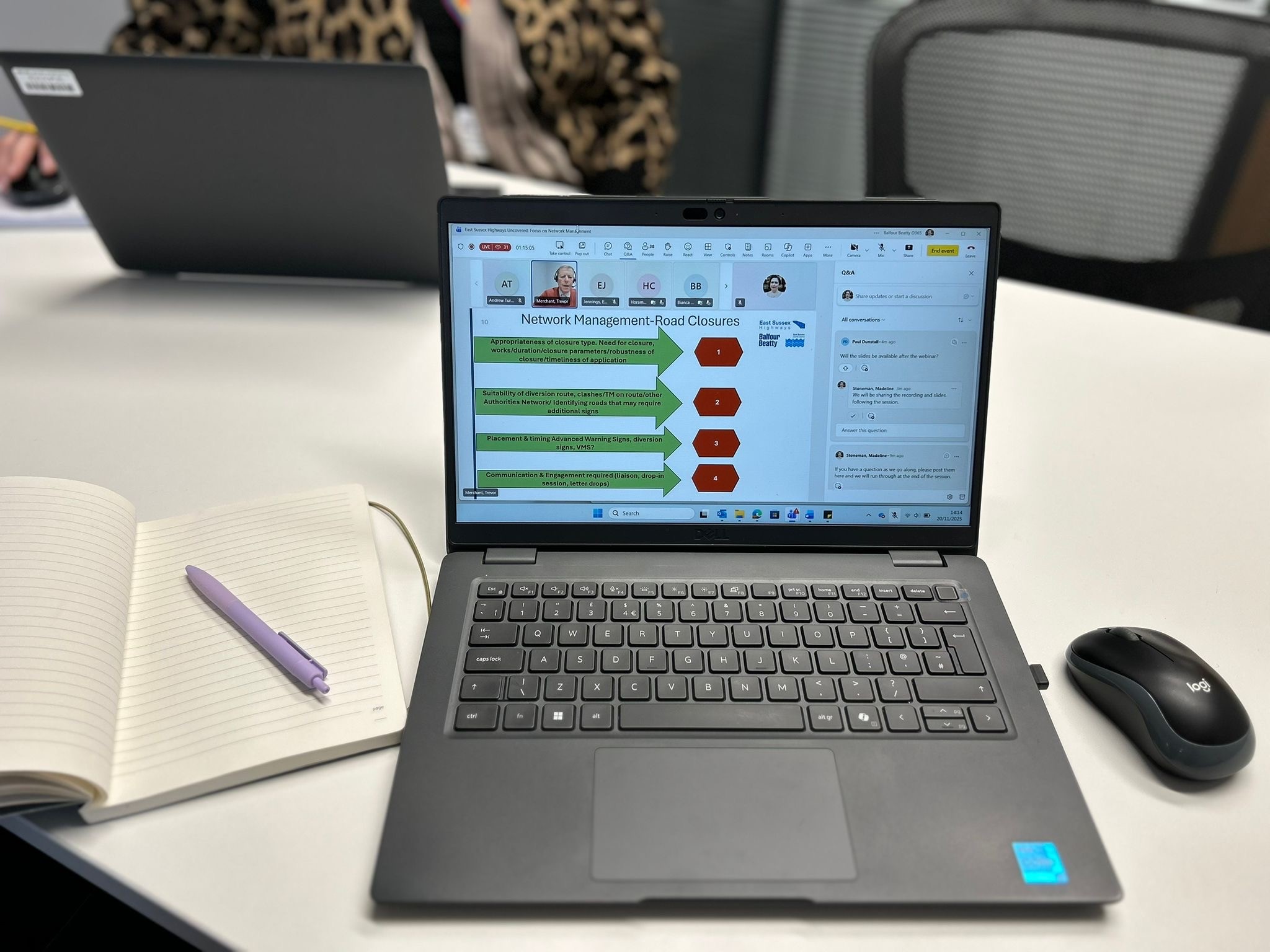 A laptop screen showing details of the webinar - focus being network management. A notebook and pen are also visible in the image.